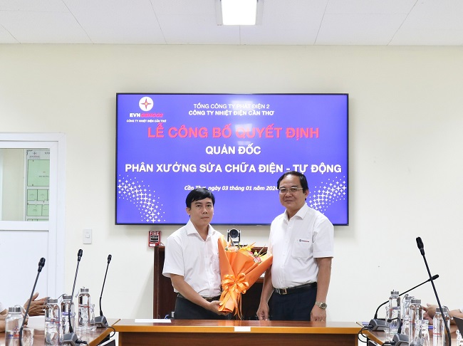 Ông Huỳnh Thanh Phong- Giám đốc Công ty Nhiệt điện Cần Thơ trao Quyết định và tặng hoa cho Ngô Nguyễn Quang Minh